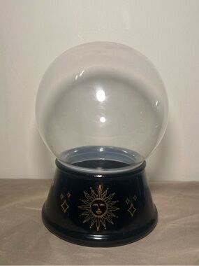 Glass globe with gold suns on it